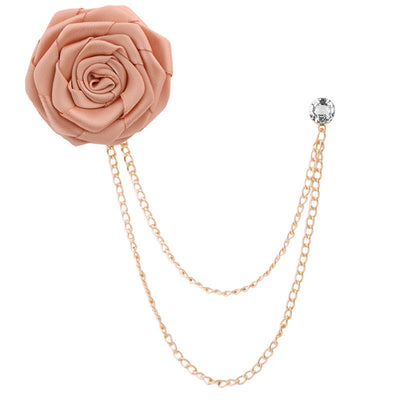 peach rose-shaped brooch with gold chain on a white background