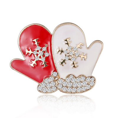 Red and white mitten-shaped brooches with gold and rhinestone details on a white background