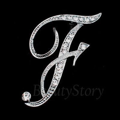 Decorative letter 'F' with crystals on a black background, branded 'Beauty Story'.