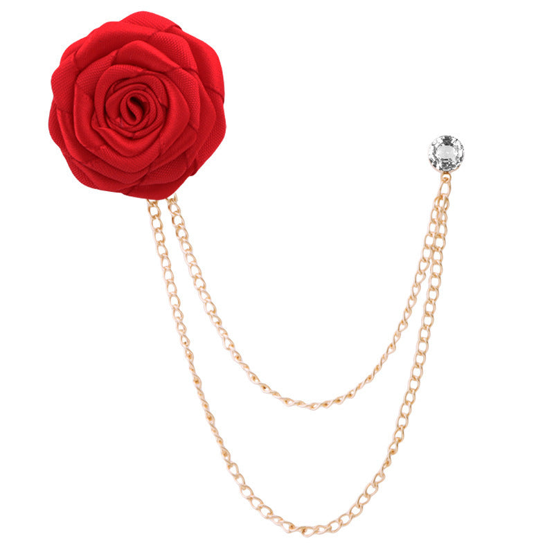 Red rose brooch with gold chain on a white background