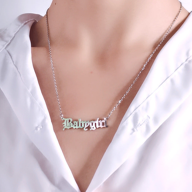 silver Necklace with 'Babygirl' pendant on a white shirt