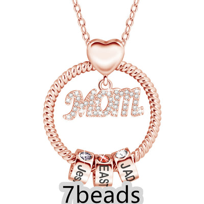 Rose gold necklace with 'Mom' and name charms on a white background 7 beads