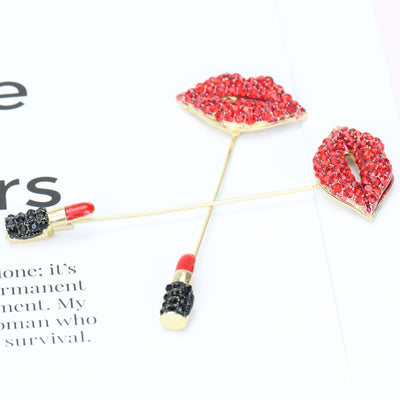 Set of brooches shaped like lips and lipsticks on a white background