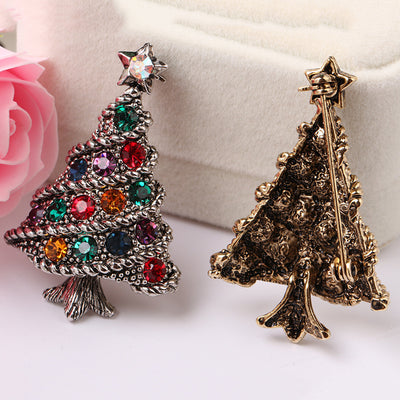  Christmas tree-shaped brooch with colorful gemstones and a star its front and its back side view on a white background.