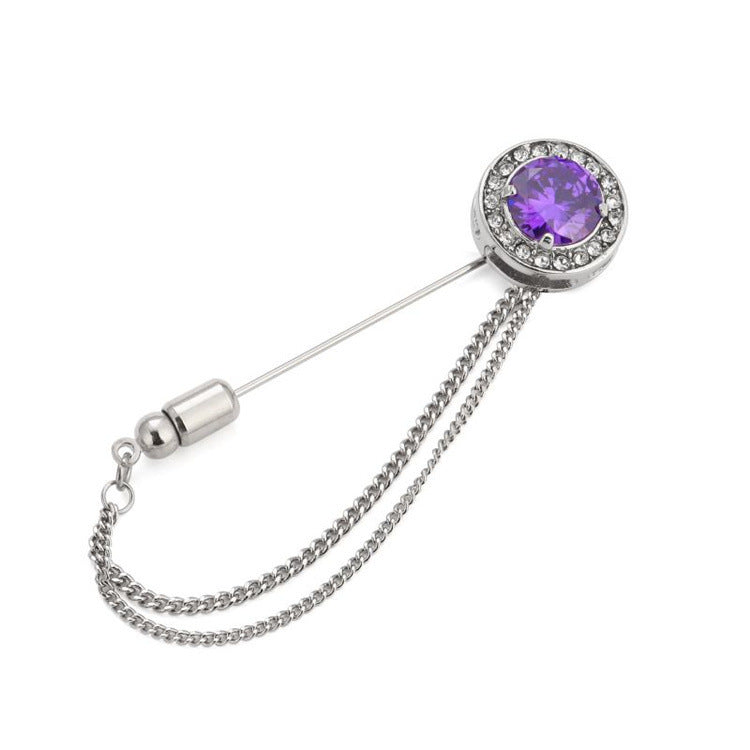 Brooch with purple gemstone and chain on a white background
