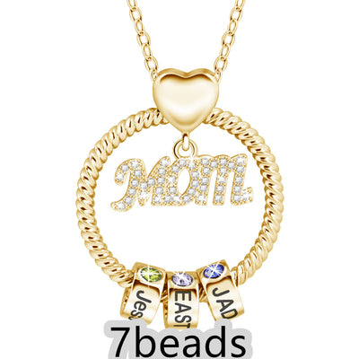 Gold necklace with 'Mom' pendant and three name beads on a white background 7 beads