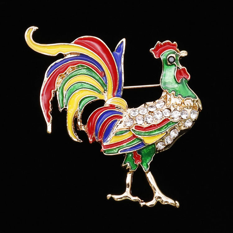Colorful rooster brooch with rhinestones on a black background