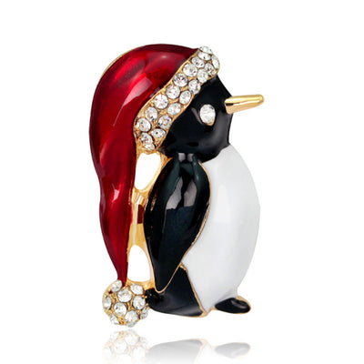 Penguin-shaped brooch with red, black, and gold colors on a white background