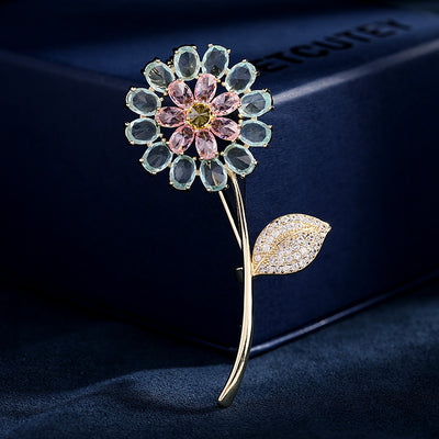 Decorative flower brooch with gemstones on a dark background