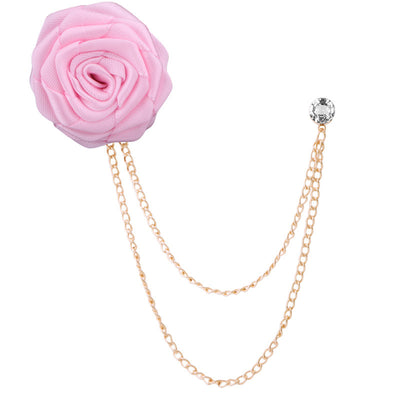 Pink flower brooch with gold chain on a white background
