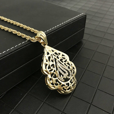 close up of Allah gold necklace with intricate filigree design and gemstone accents on a chain, placed on a dark textured surface. Elegant and luxurious tone.