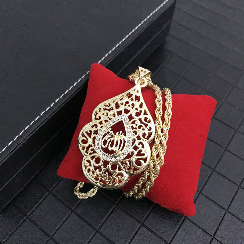 Gold necklace with intricate design and God's name Allah on a red cushion against a black background