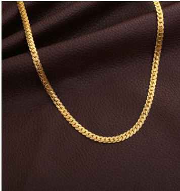 Gold chain on a brown textured background