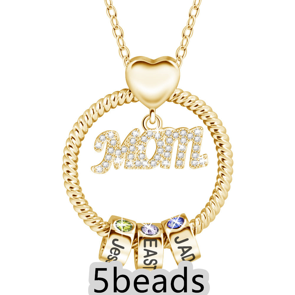 Gold necklace with 'Mom' pendant and name beads on a white background 5 beads