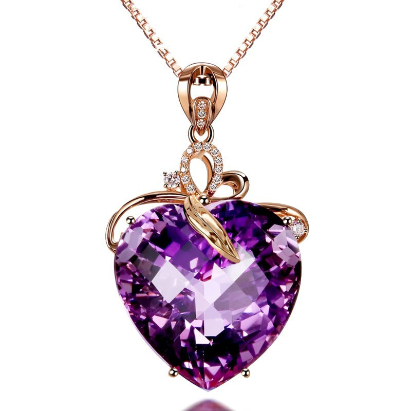 Purple heart-shaped gemstone pendant on a rose gold chain against a white background