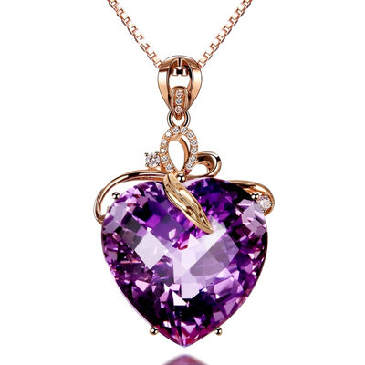 Purple heart-shaped gemstone pendant on a rose gold chain against a white background
