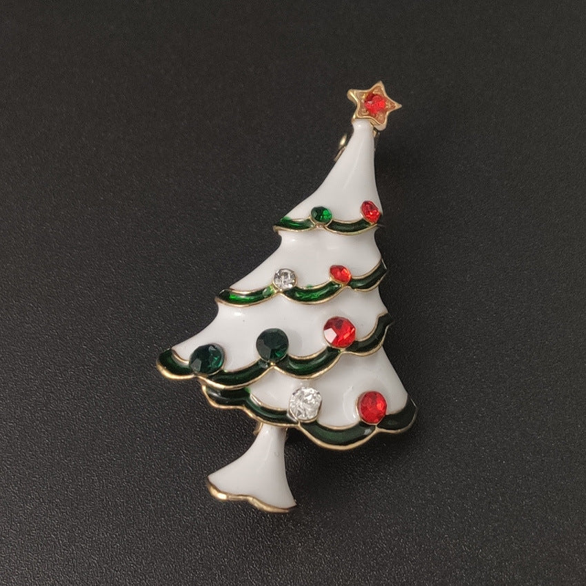 Christmas tree-shaped brooch with colorful decorations on a black background