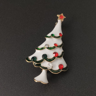 Christmas tree-shaped brooch with colorful decorations on a black background