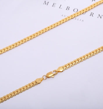 Gold chain necklace on a light gray background with 'Melbourne Australia' text.