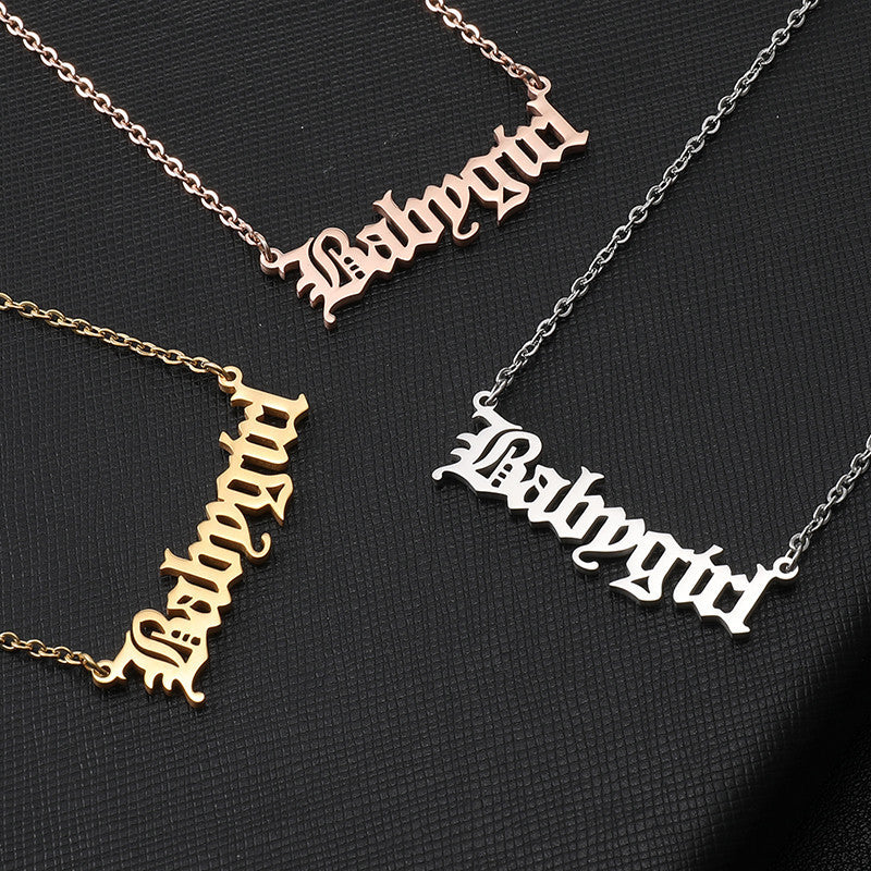 Three necklaces with 'Babygirl' pendant in different colors on a black background