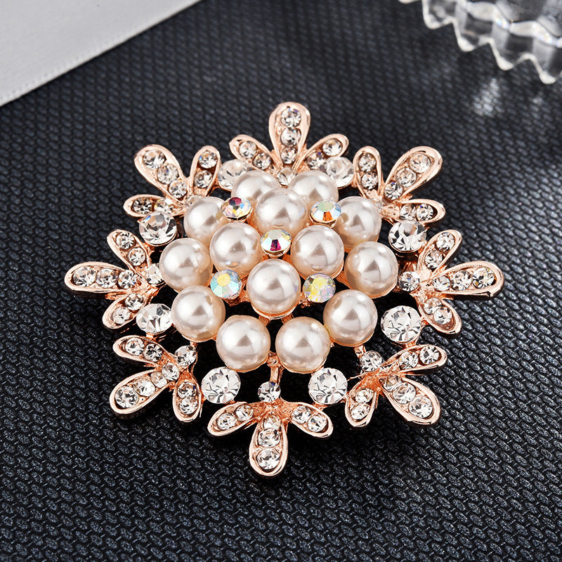 Decorative brooch with pearls and crystals on a dark textured background