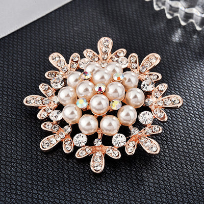 Decorative brooch with pearls and crystals on a dark textured background