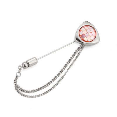 Silver brooch with a chain and pink gemstone on a white background