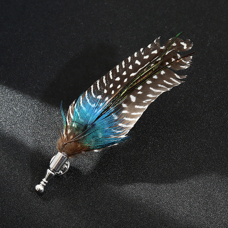 Feathered brooch with blue and brown colors on a black background