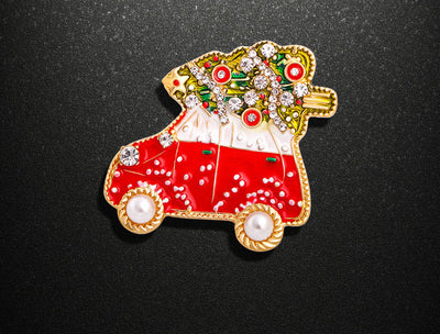 Decorative red car-shaped object with gold accents on a black background