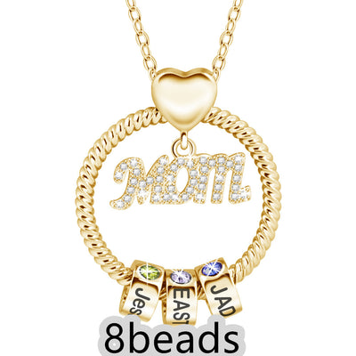 Gold necklace with 'Mom' pendant and three small cube charms on a white background. 8 beads