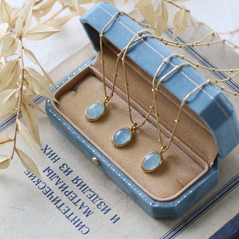 Gold necklace with blue stones on a jewelry display box
