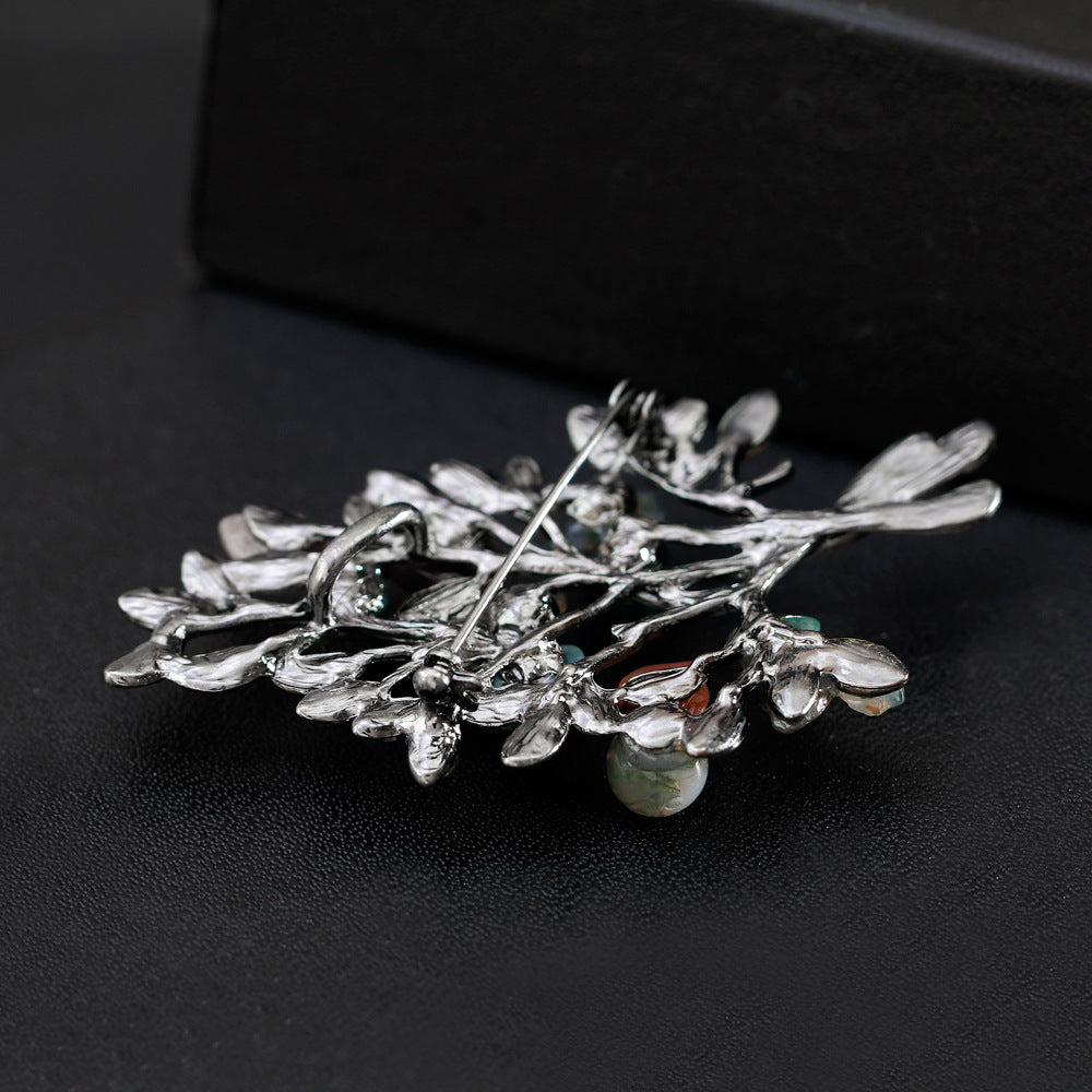 the back side of the brooch with intricate design on a black background