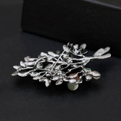 the back side of the brooch with intricate design on a black background