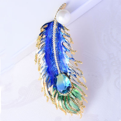 Decorative feather with blue and green colors on a white background