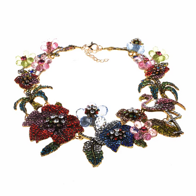 Colorful floral necklace with gemstones on a white background