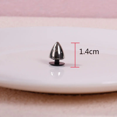 Metallic spike on a white surface with measurement label