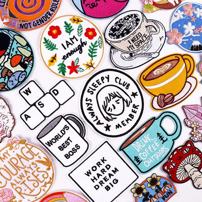 Collection of various colorful patches with different designs and text.