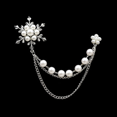 Pearl and silver chain accessory on a black background