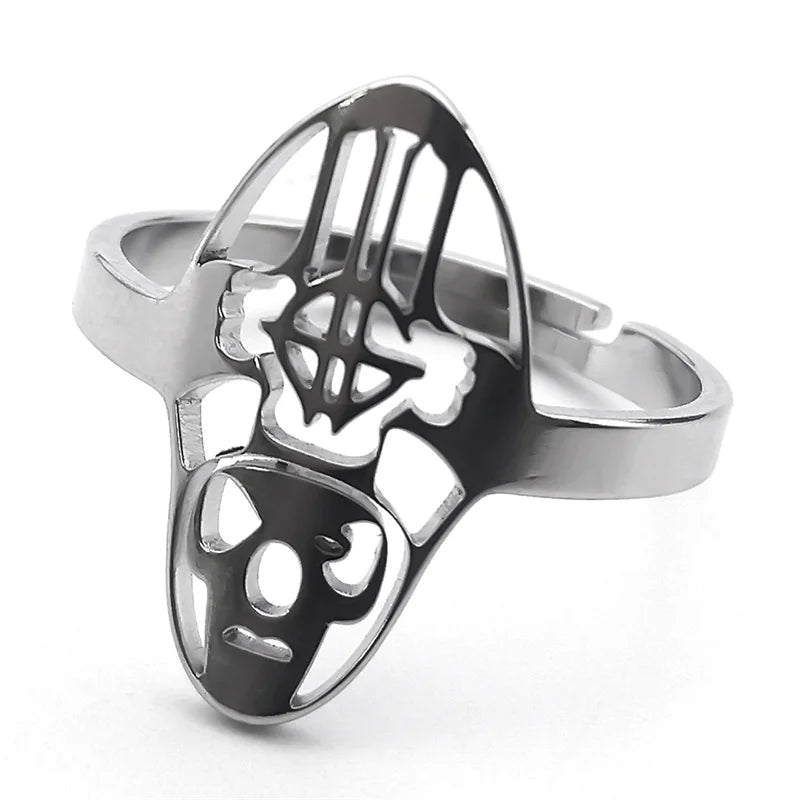 Silver ring with a unique abstract face design, featuring cut-out eyes and nose. The metal is polished, giving a sleek and modern aesthetic.