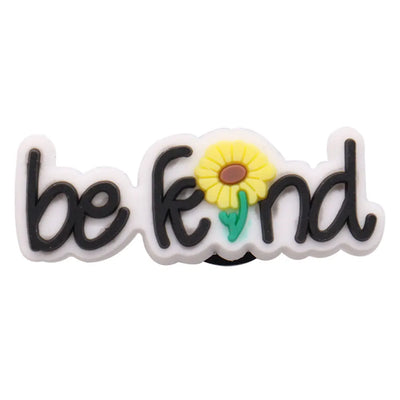 charm with 'be kind' text and a sunflower design on a white background
