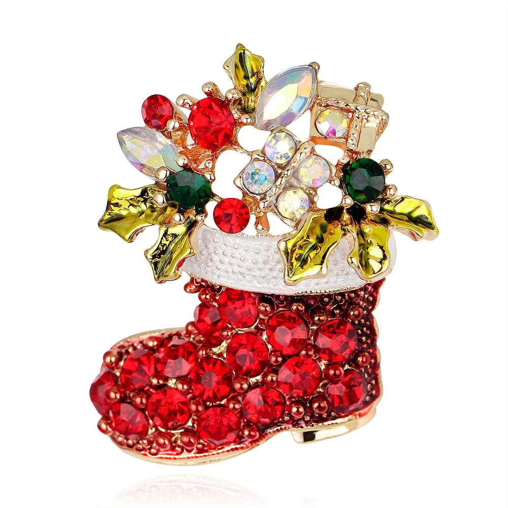 Decorative brooch shaped like a red Christmas stocking with gemstones on a white background