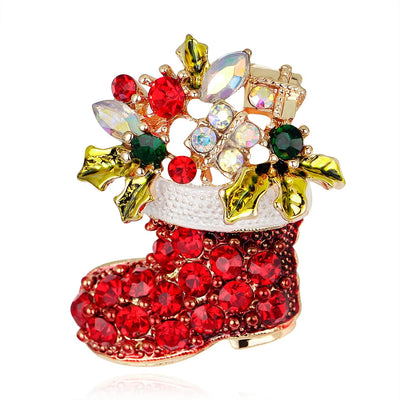 Decorative brooch shaped like a red Christmas stocking with gemstones on a white background