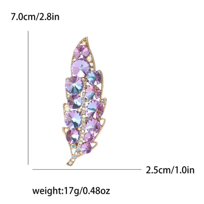 Multicolored feather-shaped brooch with measurements and weight on a white background