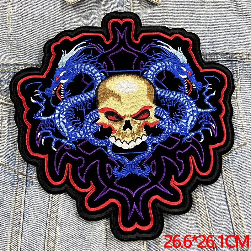 Embroidered patch with skull and dragons design on denim fabric
