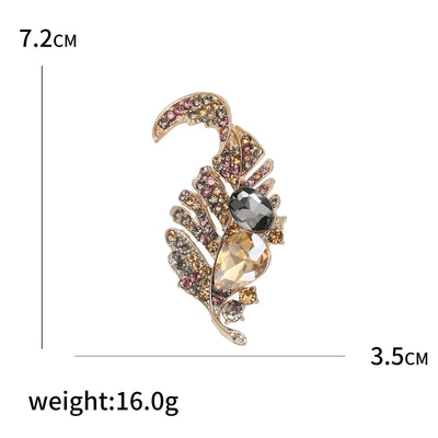 Decorative brooch with gemstones and measurements on a white background