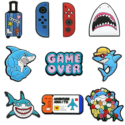 Collection of colorful shark-themed shoe charms and stickers on a white background