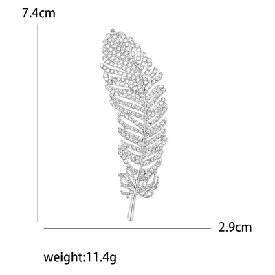 Silver feather-shaped brooch with measurements and weight displayed