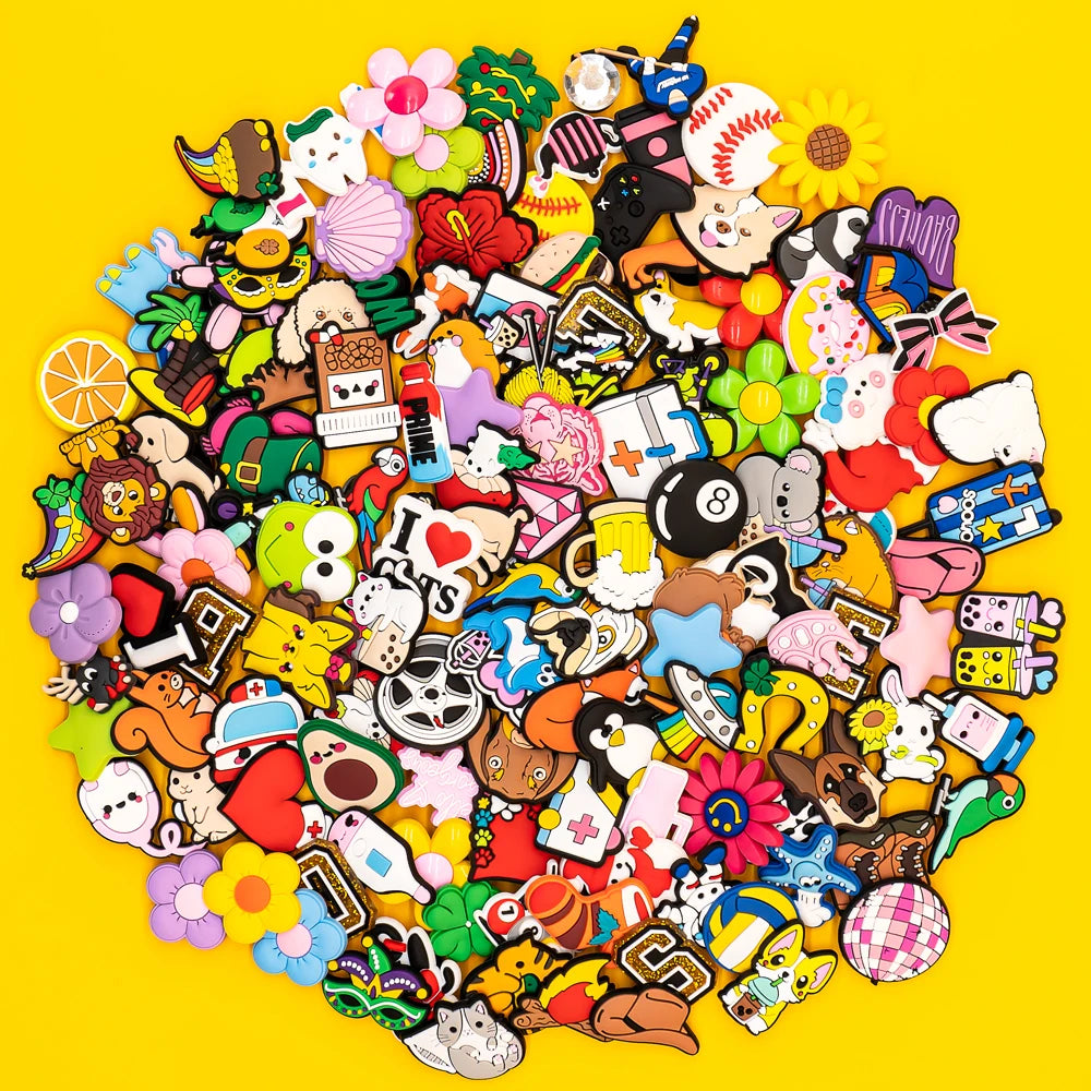 Collection of various colorful shoe charms on a yellow background