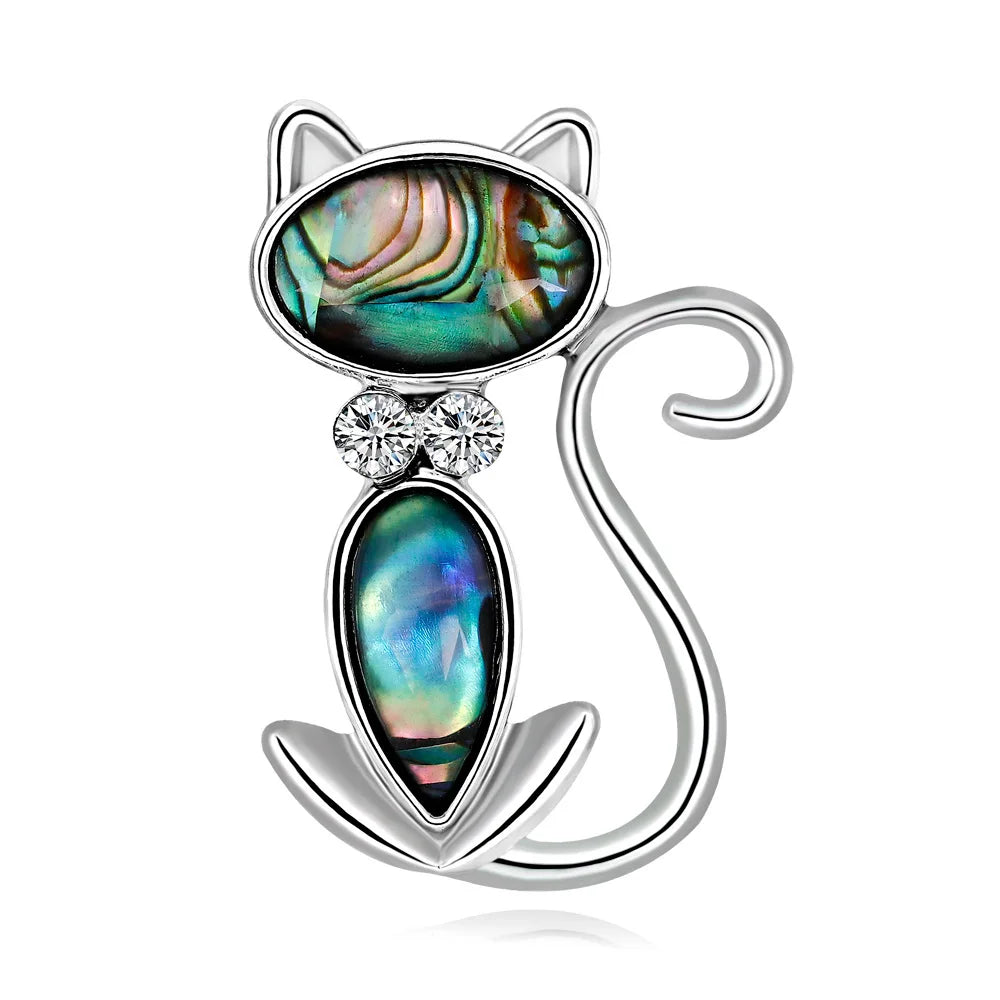 Silver Cat-shaped brooch with abalone shell and crystal on a white background