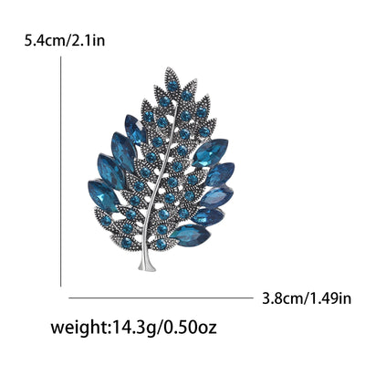 Blue leaf-shaped brooch with measurements and weight details on a white background
